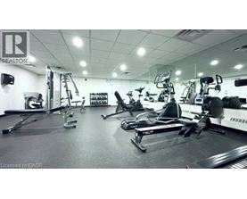 A gym with a variety of exercise equipment including treadmills, stationary bikes, and weight machines.