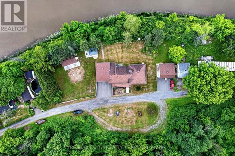 An aerial view of a residential area with houses and trees.
