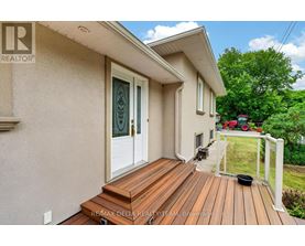 A house with a wooden deck and a glass door.