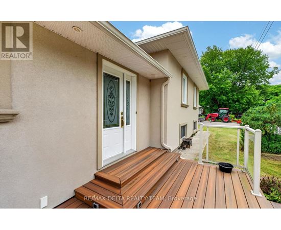 A house with a wooden deck and a glass door.