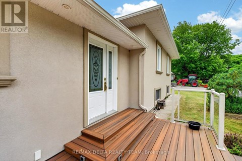 A house with a wooden deck and a glass door.