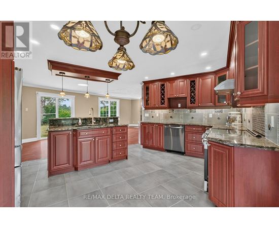 A kitchen with red cabinets and a large island.