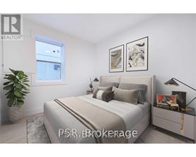 A bedroom with a large bed, a potted plant, and two framed pictures on the wall.