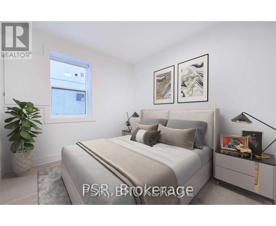 A bedroom with a large bed, a potted plant, and two framed pictures on the wall.