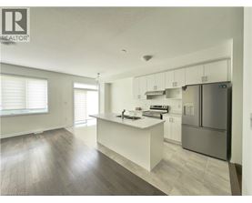 A modern kitchen with white cabinets and a central island.