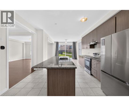 A modern kitchen with stainless steel appliances and a central island.