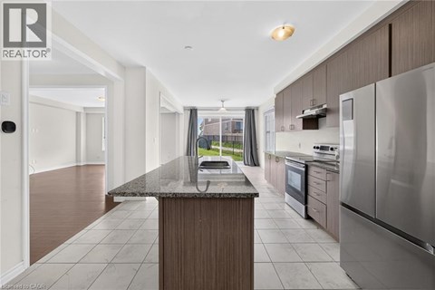 A modern kitchen with stainless steel appliances and a central island.