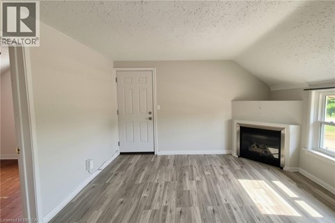 A room with a fireplace and a door.