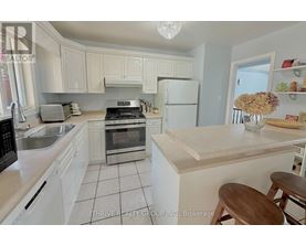 A kitchen with white cabinets and a wooden island.
