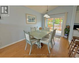 A dining room with a glass table and chairs.