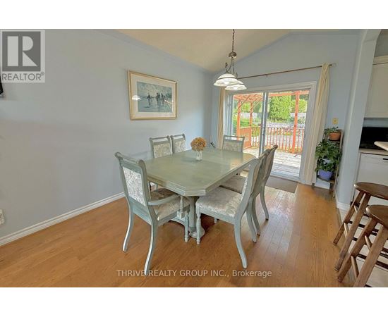 A dining room with a glass table and chairs.