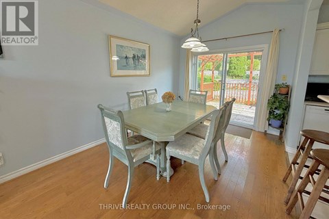 A dining room with a glass table and chairs.