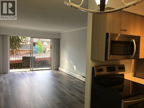 A modern kitchen with a microwave and oven built into the cabinetry.