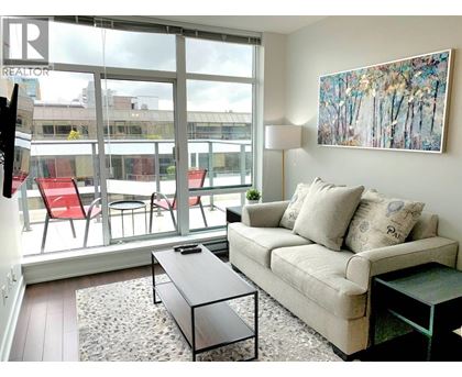 A living room with a couch, chairs, and a painting on the wall.