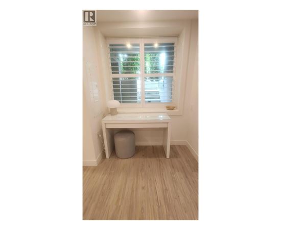 A room with a window and a desk.