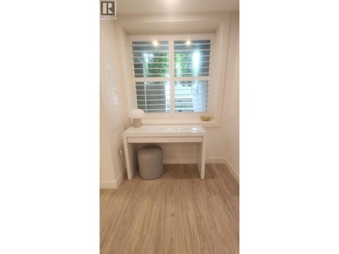A room with a window and a desk.