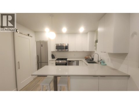 A kitchen with white cabinets and a countertop.