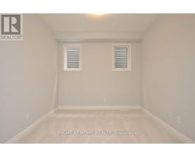 A room with a window and a ceiling light.