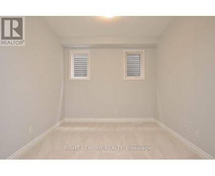 A room with a window and a ceiling light.