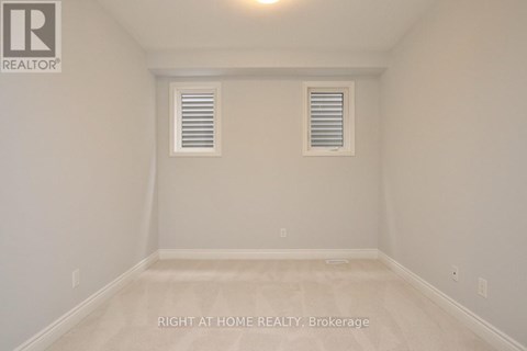 A room with a window and a ceiling light.