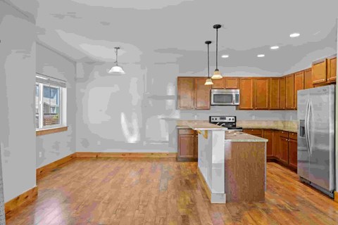 A kitchen with wooden cabinets and a white island.