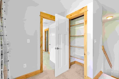 A room with a white door and a window.