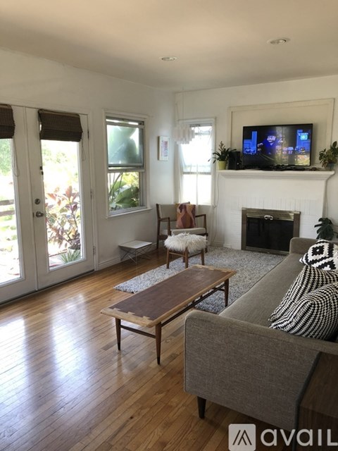 A living room with a grey couch and a wooden coffee table.