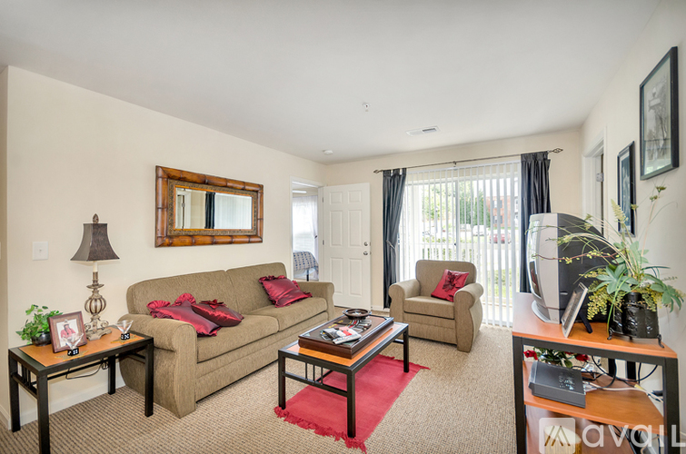 A living room with a couch, chair, and coffee table.