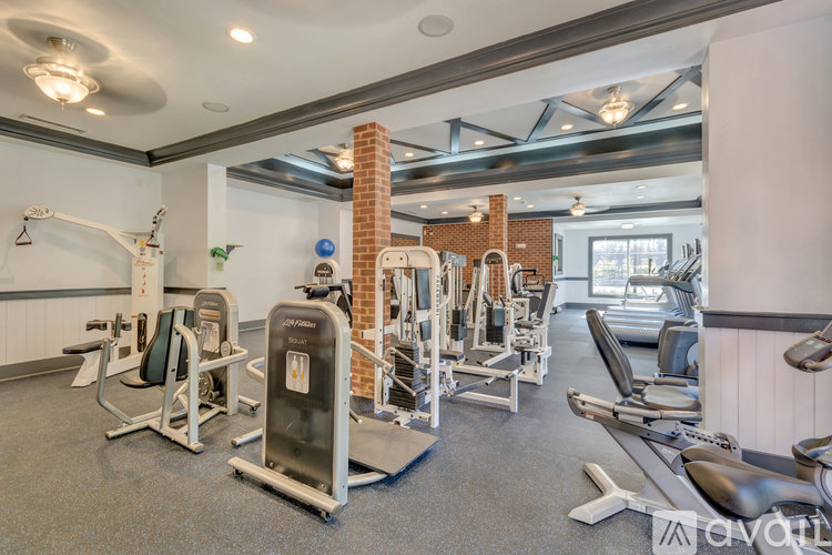 A well-equipped gym with a variety of machines and weights.