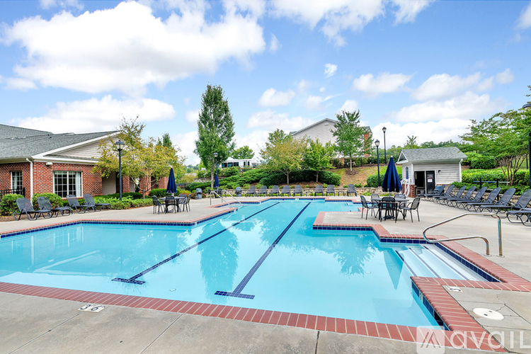A swimming pool with a red brick border and a blue pool area.