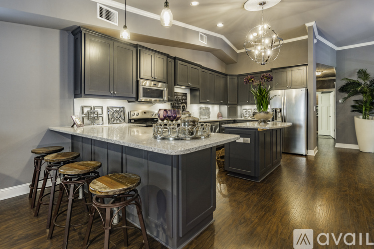 A modern kitchen with dark wood cabinets and a central island.