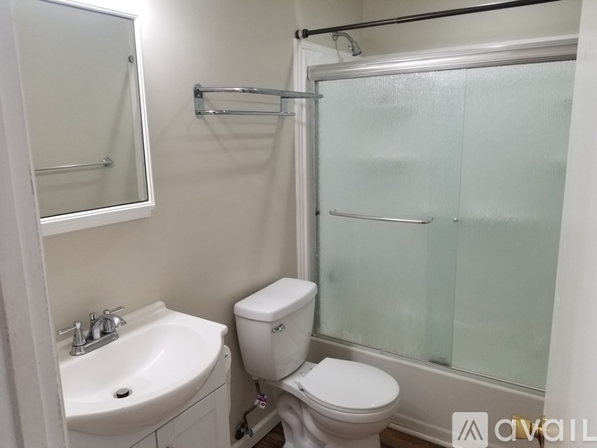A white toilet sits next to a sink in a small bathroom.