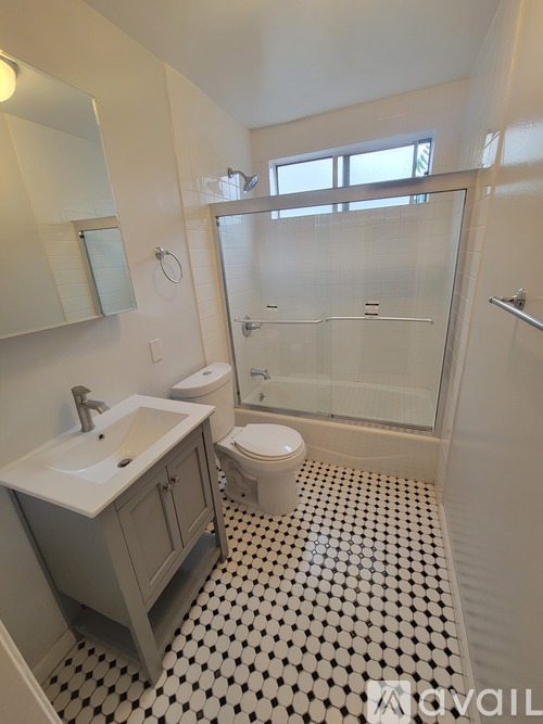 A bathroom with a sink, toilet and shower.