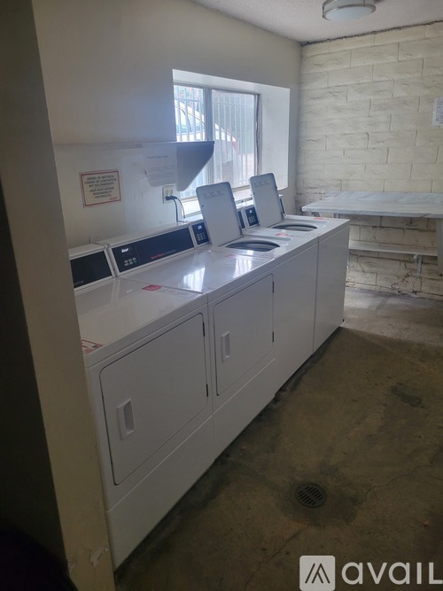 A white reception desk with a sign on it.