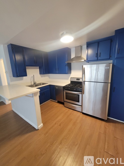 A kitchen with blue cabinets and a white island.
