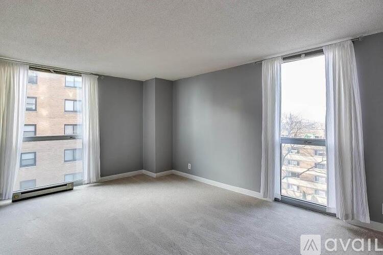 A spacious room with a view of a building outside the window.