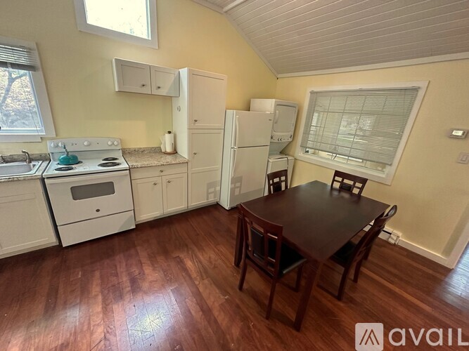 A kitchen with a table and chairs in the middle of the room.