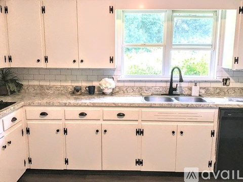 A kitchen with pink cabinets and a sink.