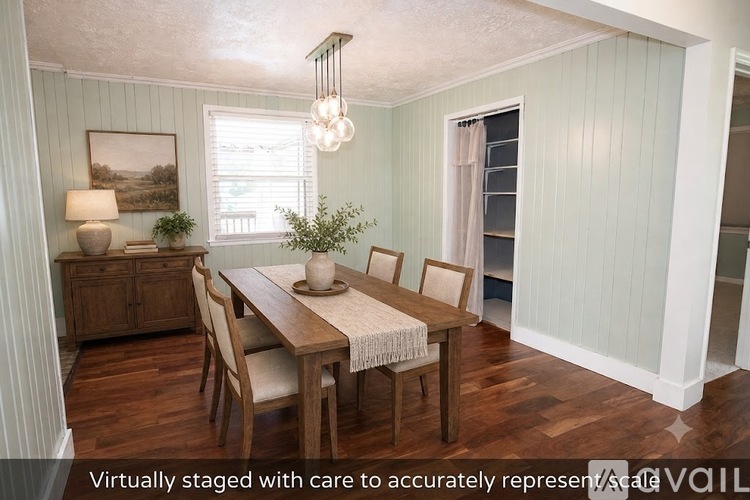 A dining room with a wooden table and chairs.