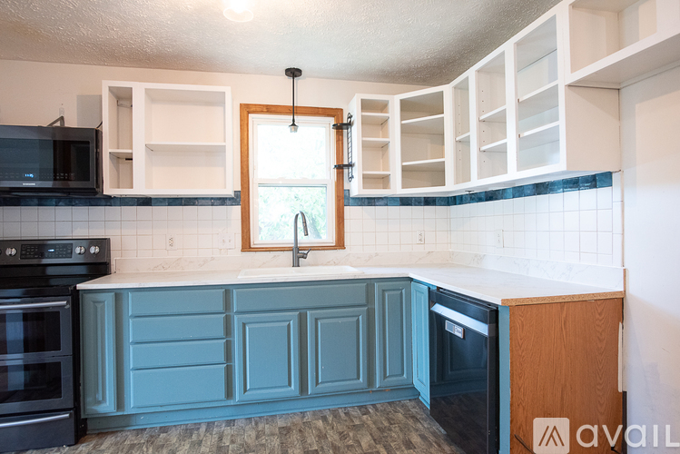 A kitchen with a black oven and a black microwave.