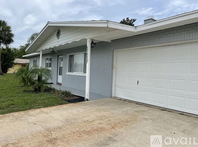 A house with a white garage door is for sale.