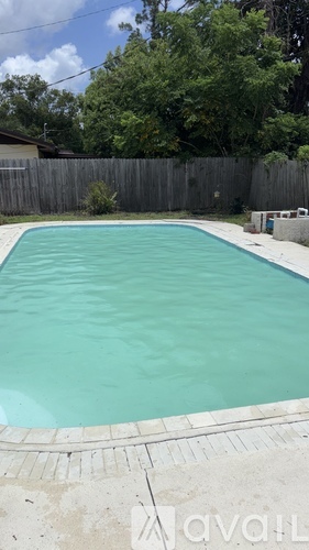 A small residential pool with a concrete border.
