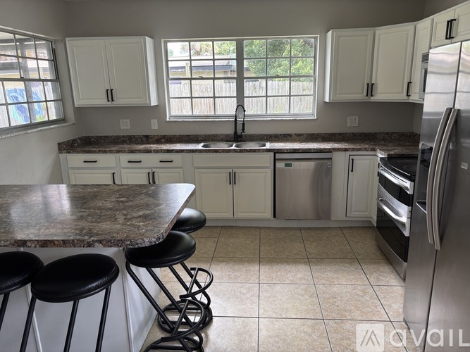 A kitchen with granite countertops and stainless steel appliances.