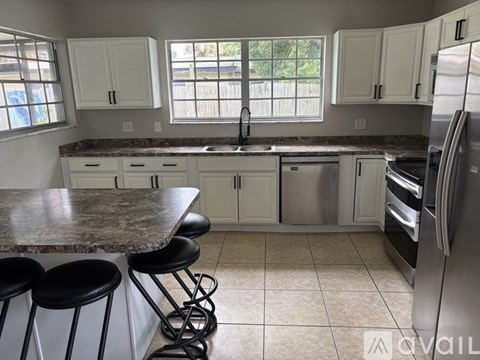 A kitchen with granite countertops and stainless steel appliances.
