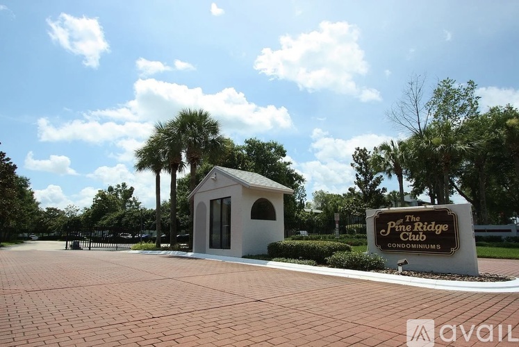 The Ridge Club Condominiums sign is in front of a building.