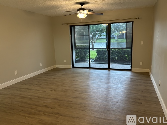 A room with a sliding glass door leading to a backyard.