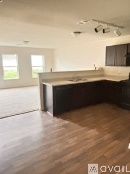 A kitchen with wooden floors and a large island.