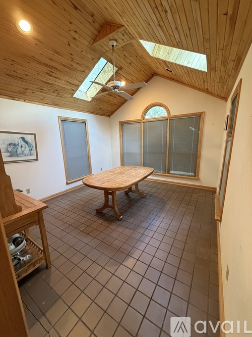A room with wooden floors and a large window.