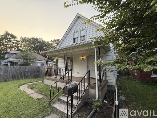A house with a front porch and a mailbox.