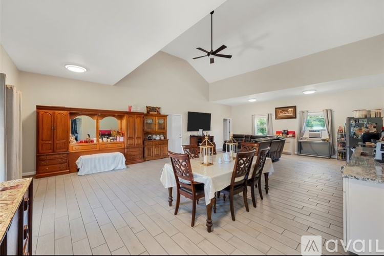 A kitchen with a dining table and chairs.